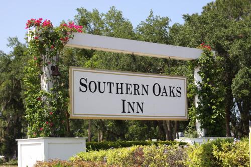 a sign for southern oaks inn in a garden at Southern Oaks Inn - Saint Augustine in Saint Augustine