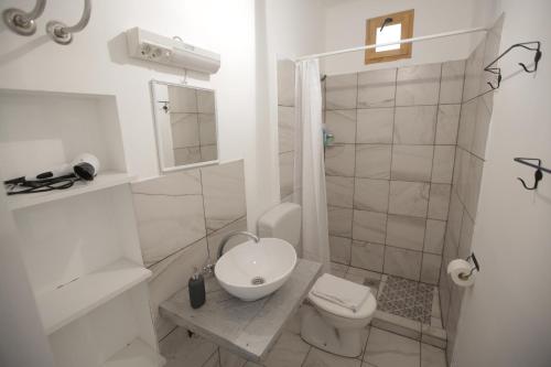 a white bathroom with a toilet and a shower at Pannonia Terranova in Vardarac