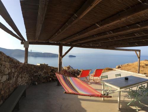 a group of chairs and a table on a patio at Scorpio house 180 sea view - Serifians Residences in Serifos Chora