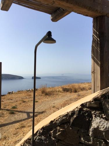a street light next to a building with a view of the ocean at Scorpio house 180 sea view - Serifians Residences in Serifos Chora