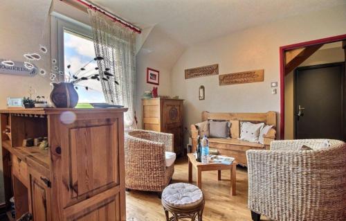 a living room with a couch and a table at Les Chambres de Kermenguy in Sibiril