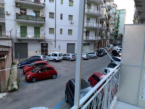 a group of cars parked in a parking lot next to a building at B&B In Centro in Crotone