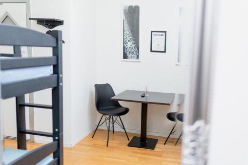 a small table and chairs in a room with a staircase at CarlstadCity H Boutique Hotell in Karlstad