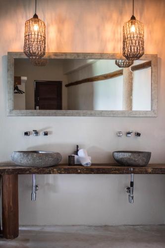 a bathroom with two sinks and a mirror at Spirit Holbox in Holbox Island