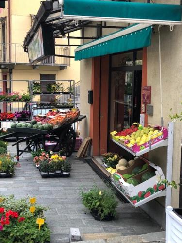 a fruit and vegetable stand in front of a store at Luxury Apartment Lake Como in Acquaseria