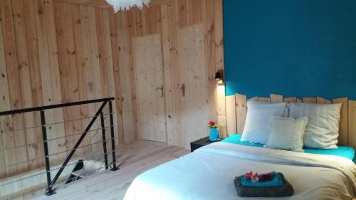 Brennilis的住宿－Gîte et Salers des Monts d'Arrée，一间卧室设有一张床和蓝色的墙壁