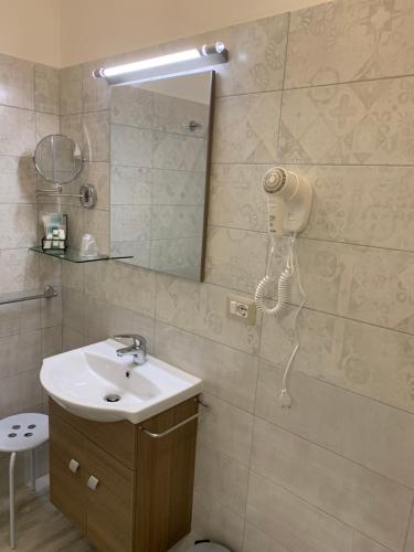 a bathroom with a sink and a phone on the wall at B&B In Centro in Crotone