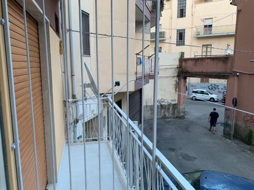 a man walking down a street next to a building at B&B In Centro in Crotone