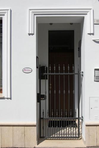a front door of a white house with a gate at Orchidea Rooms & Suites in Civitanova Marche