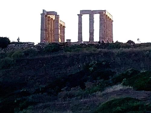 an old building on top of a hill at me gusta suite by the sea in Anavissos