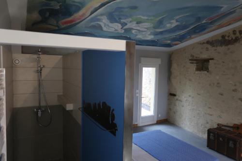 a bathroom with a painting on the ceiling at tempepailla in Roynac