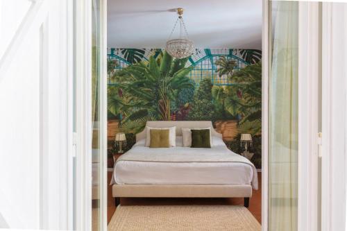 a bedroom with a bed with a tropical wallpaper at Villa Zagara - La Serra in Sorrento