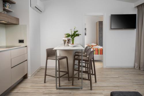 a kitchen with a white table and chairs at Holiday Homes Kanajt in Punat
