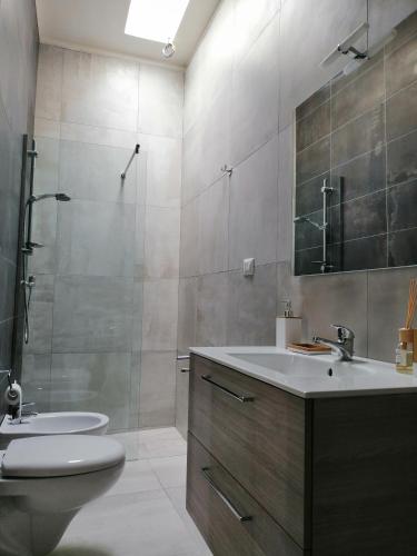 a bathroom with a sink and a toilet and a shower at DoppioBi in Torre Lapillo