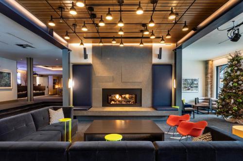 a living room with a couch and a fireplace at Limelight Hotel Snowmass in Snowmass Village