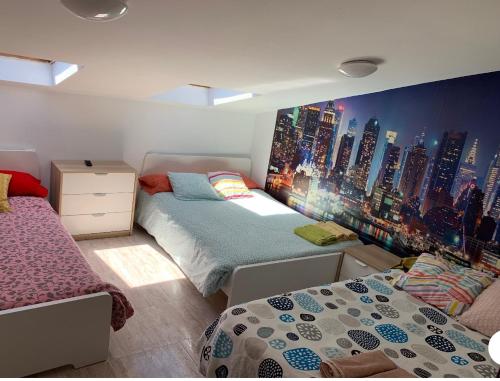 萊昂的住宿－¡PRECIOSO ATICO EN LA PLAZA MAYOR!，一间带两张床的卧室和城市壁画
