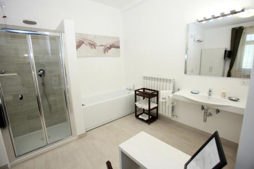 a bathroom with a shower and a sink at Orchidea Rooms & Suites in Civitanova Marche