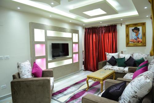 a living room with two couches and a tv at City Square Bay View in Alexandria