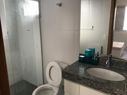 a bathroom with a toilet and a sink at Locking's Grajaú 7 in Belo Horizonte