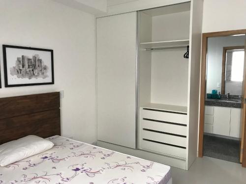 a bedroom with a bed and a mirror at Locking's Grajaú 7 in Belo Horizonte