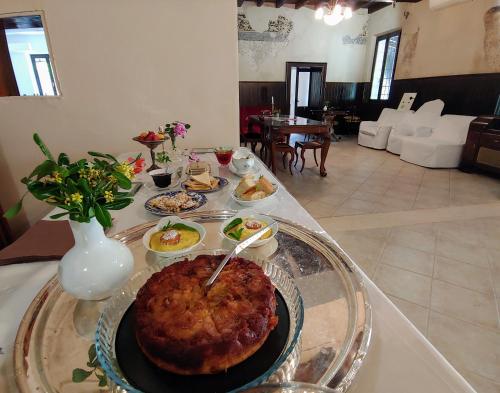 a table with a plate of food on a table at Corte Mantovanella in SantʼAntonio
