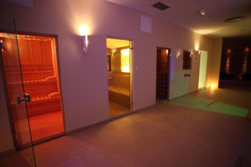 a room with a hallway with a walk in closet and a mirror at Medjugorje Hotel & Spa in Međugorje