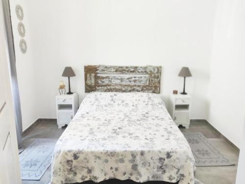 a bedroom with a bed and two night stands at Pinheiro de Monsaraz-Casas da Colmeia T2 in Reguengos de Monsaraz