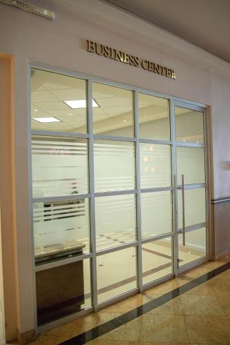 a building with a glass door with a business center at Hotel Ticuán in Tijuana