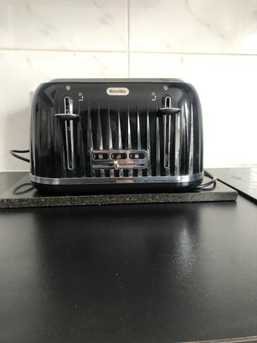 a toaster sitting on top of a counter at Modern Apartment in Trendy Dalston in London