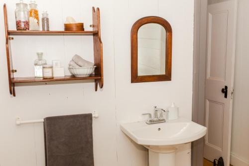 a bathroom with a sink and a mirror at Le Vieux Presbytère in Saint-Vallier