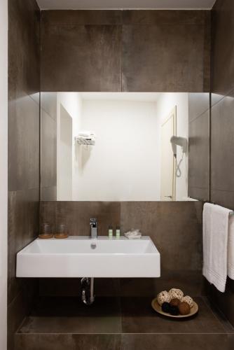 a bathroom with a white sink and a mirror at I Pianelli in Murlo