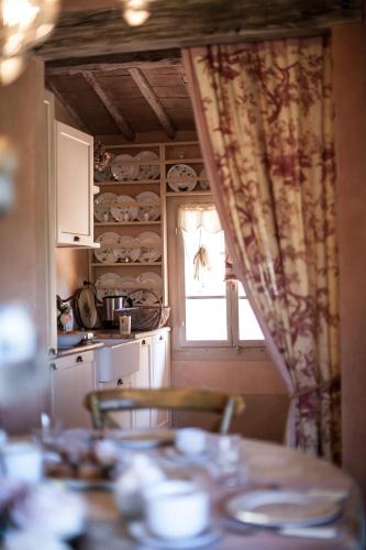 a kitchen with a table and a window at Podere La Strega in Siena