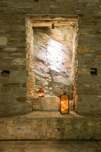 a stone wall with a candle in a window at Pelion Goddess Villas in Agios Georgios Nilias