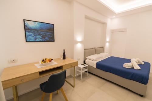 
a bedroom with a bed and a desk at Antares B&B and SUITES in Olbia
