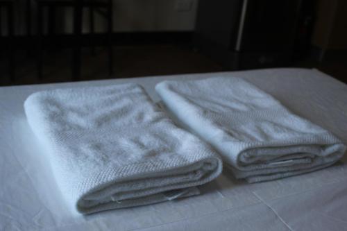 two towels sitting on top of a bed at Antonio's Place, 3 mins to Mactan Airport, Fast Internet with Netflix in Mactan