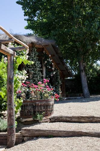 a wooden structure with flowers in a garden at Podere La Strega in Siena