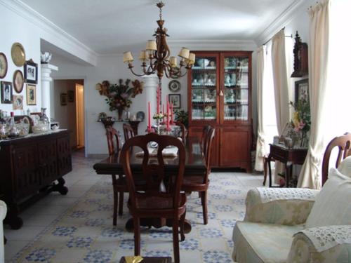 a living room with a table and chairs at Casa Do Adro Da Igreja Turismo De Habitação in Vila Nova de Milfontes