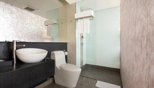 a bathroom with a white toilet and a sink at Empire Hotel Subang in Subang Jaya