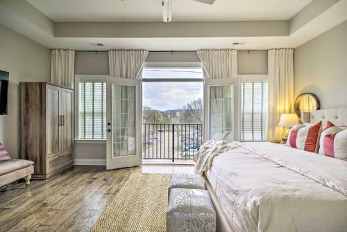 a bedroom with a large bed and a balcony at Downtown Retreat in Chattanooga