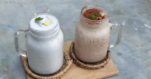 two jars of milkshakes sitting on a cutting board at Memo's Beach in Nilaveli