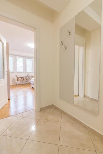 an empty living room with a large mirror on the wall at Comfy Apartments-Ohrid in Ohrid