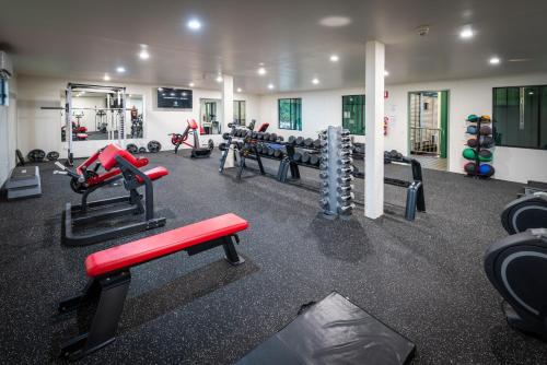 a gym with treadmills and machines in a room at Victoria Village in Katherine