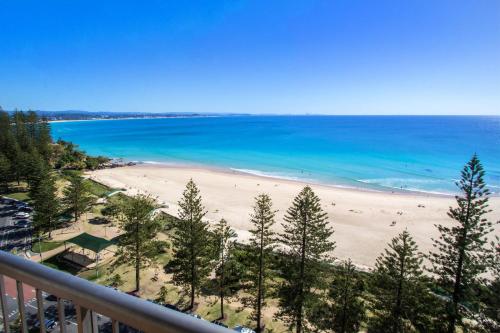 a view of a beach with trees and the ocean at Columbia Beachfront Apartments on Rainbow Bay in Gold Coast