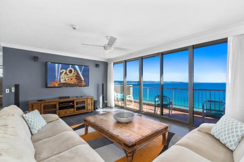 a living room with a view of the ocean at Columbia Beachfront Apartments on Rainbow Bay in Gold Coast