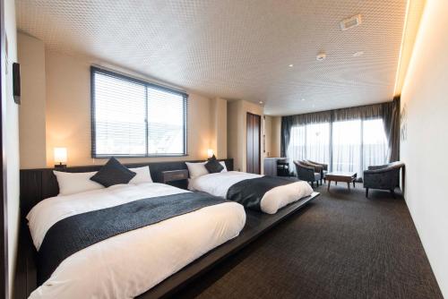 Postel nebo postele na pokoji v ubytování Hotel ZIZI Kyoto Gion