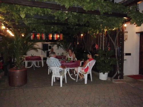 a group of people sitting at a table in a restaurant at Landgasthaus Zur Kupferkanne in Kobern-Gondorf