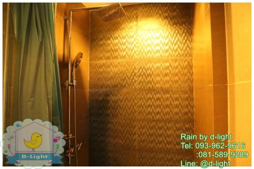 a bathroom with a shower with a shower curtain at Rain Cha-am Hua Hin by D-light in Cha Am