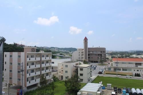 a view of a city with buildings and a clock tower at M´s Stay Okinawa in Chatan
