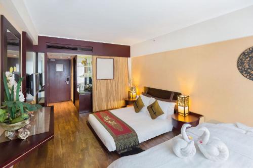 a hotel room with two beds and two towels at Regal Airport Hotel in Hong Kong