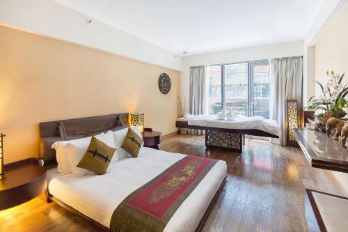 a hotel room with a bed and a bathroom at Regal Airport Hotel in Hong Kong